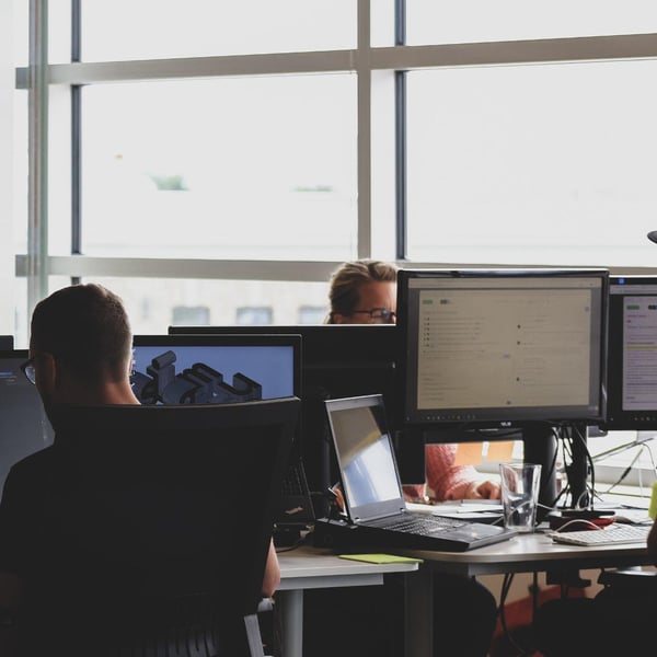 Work office with several computers and screens. 